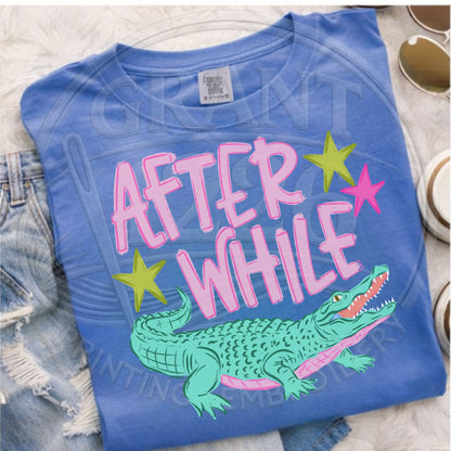 After While crocodile graphic tee close up blue shirt pink lettering croc design detail