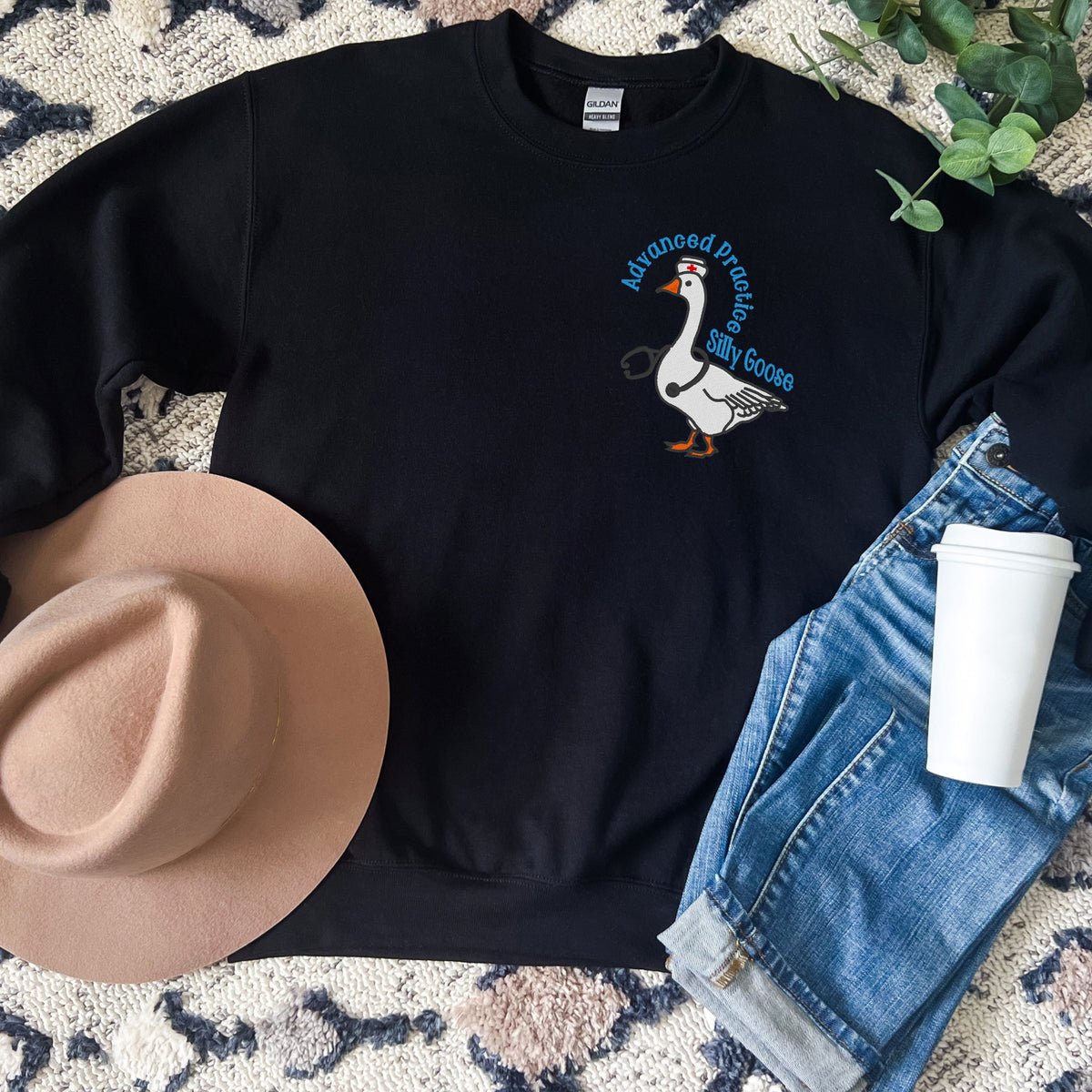 Black APRN Silly Goose crewneck styled in a western flat lay