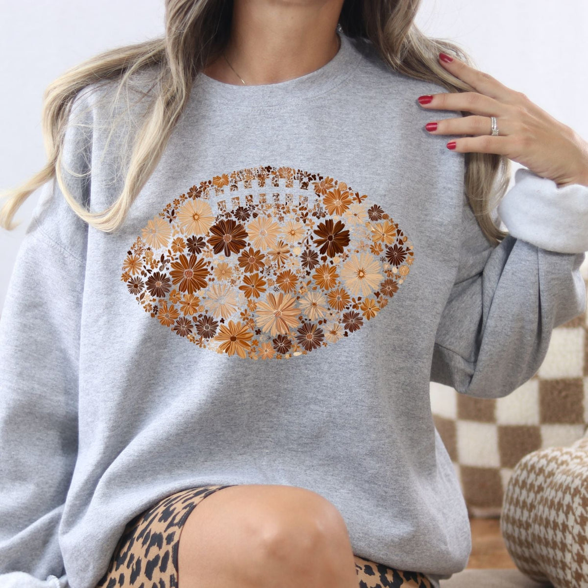 Ash floral football sweatshirt shown as a relaxed game day outfit