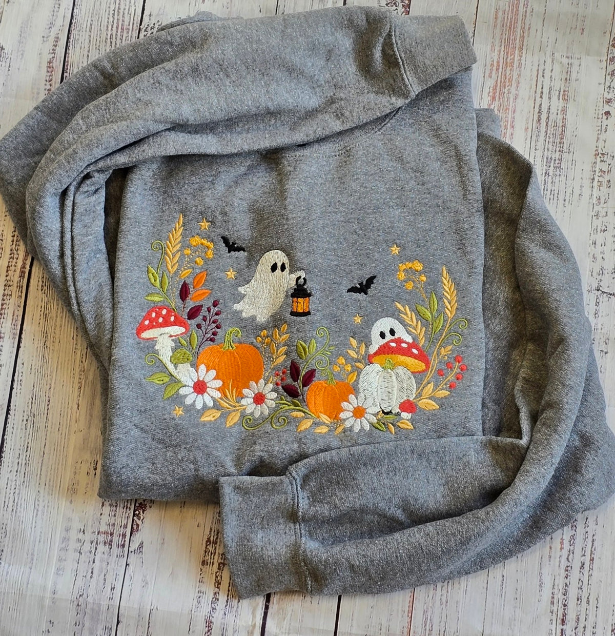 Ash floral ghost pumpkin and mushroom embroidered Halloween sweatshirt real product photo