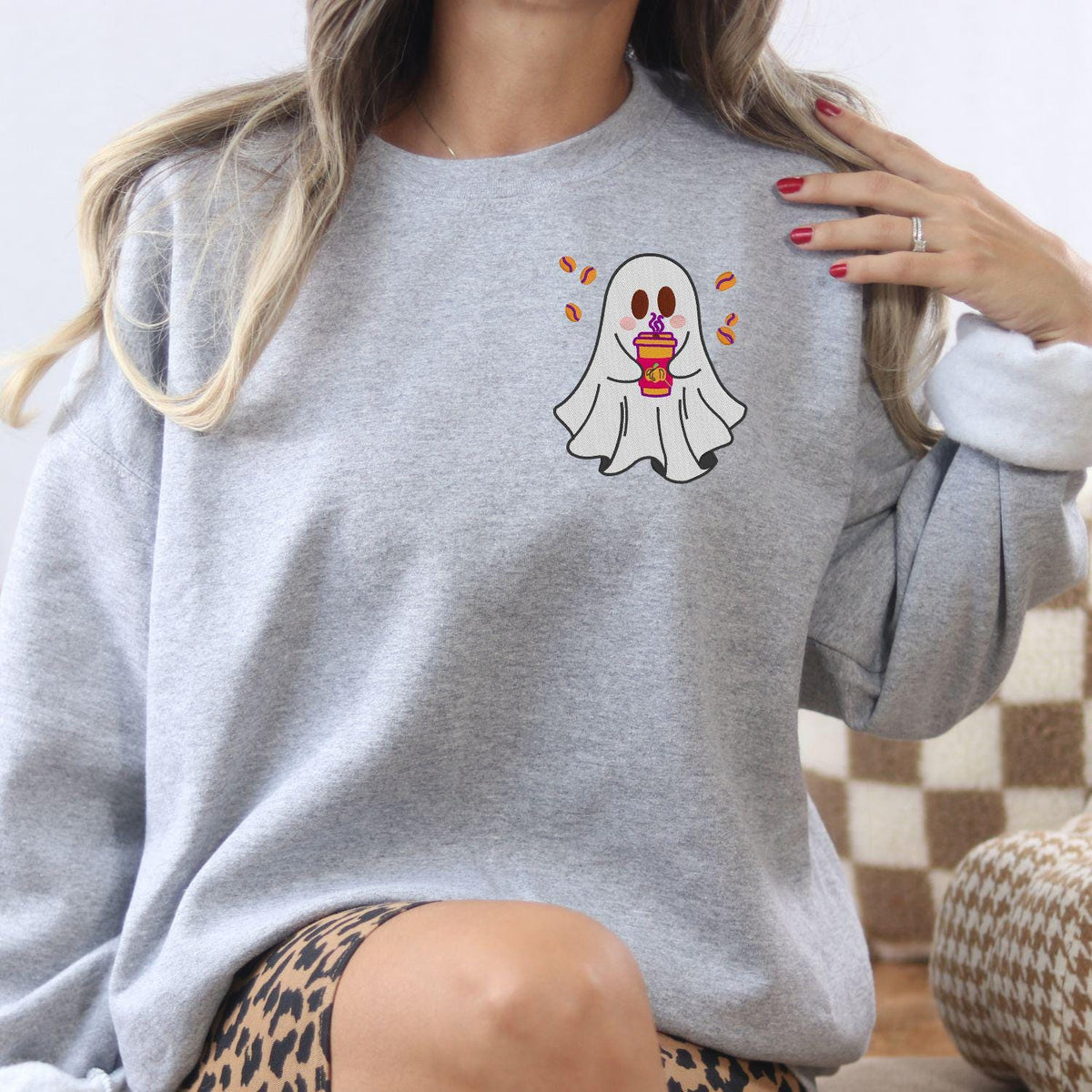 Ash embroidered crewneck with a ghost holding a colorful fall coffee cup