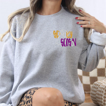 Ash Spooky Season ghost embroidered sweatshirt shown in a relaxed lifestyle view