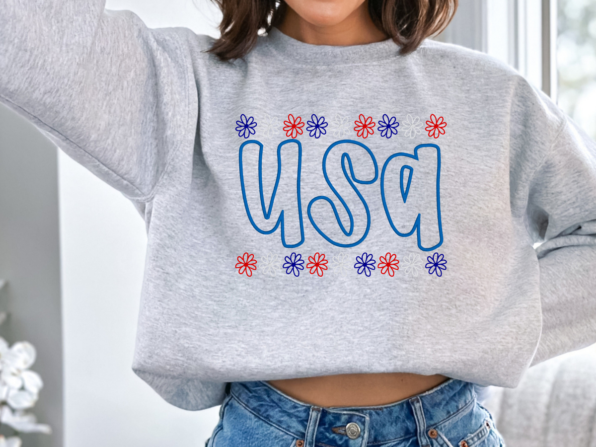Ash Gildan USA puff-embroidery crewneck sweatshirt with red, white, and blue daisy borders on model