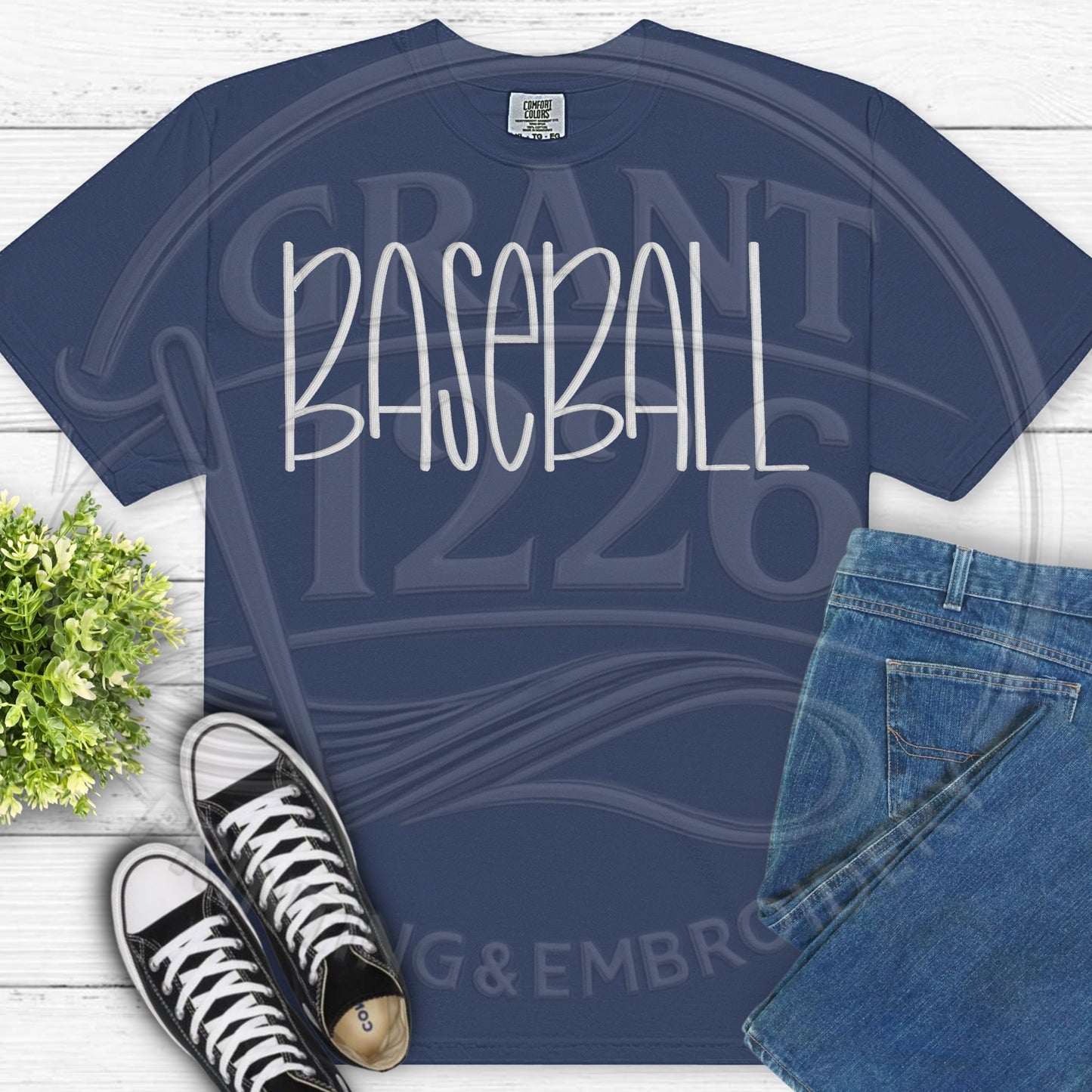 Flat lay personalized baseball shirt on navy Comfort Colors tee