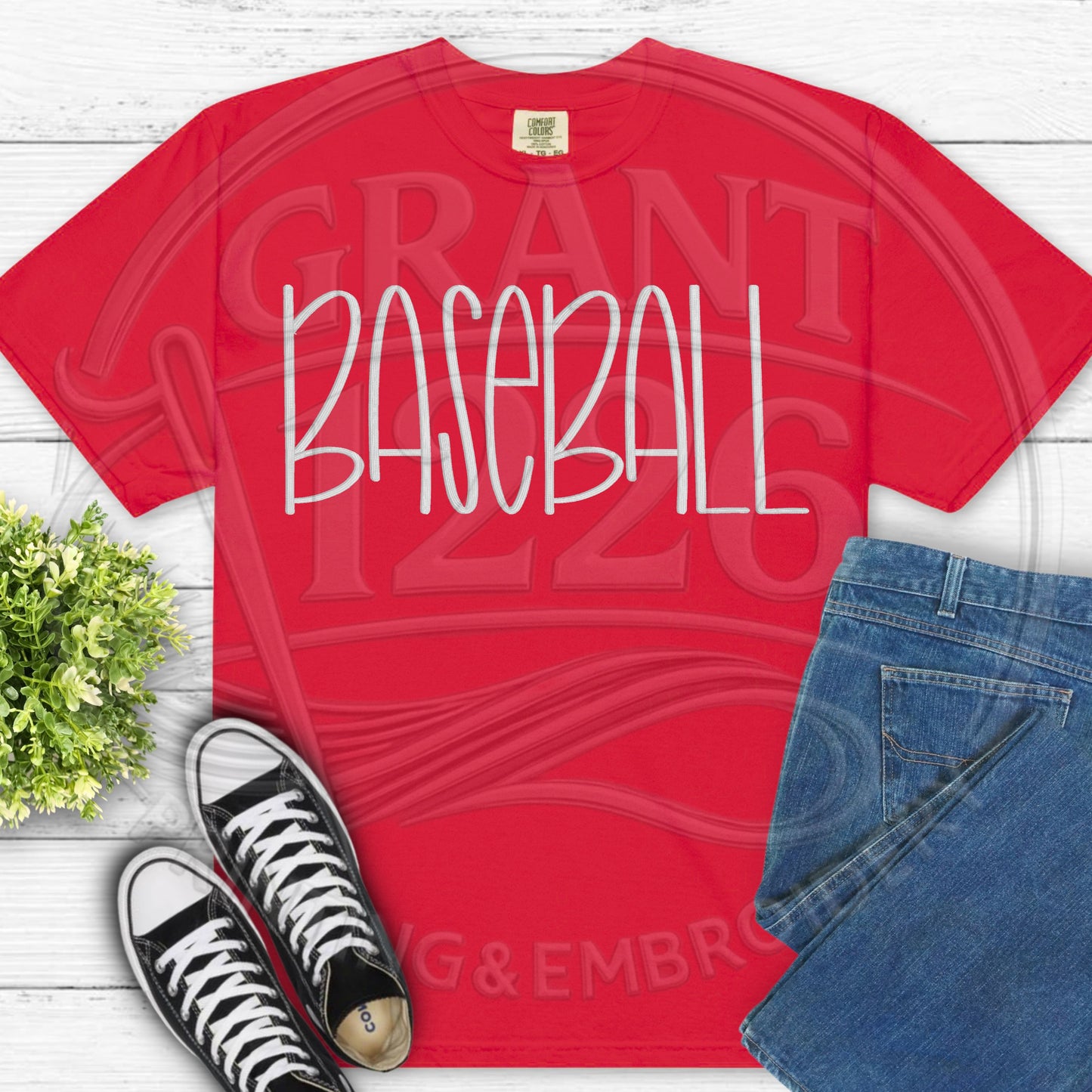 Red custom embroidered baseball shirt flat lay product photo