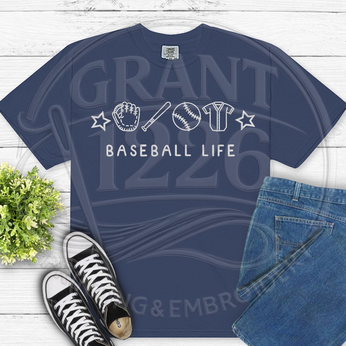 Navy blue baseball life shirt flat lay with jeans and sneakers