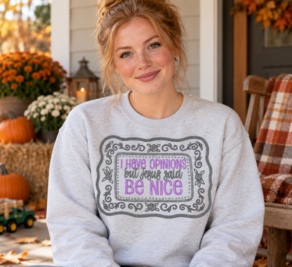 Woman wearing an Ash Grey embroidered sweatshirt with I Have Opinions But Jesus Said Be Nice lavender and grey floral frame design