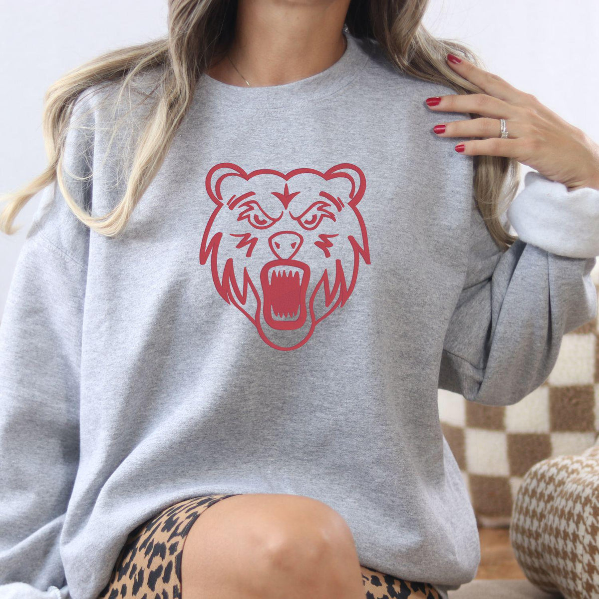 Sport gray full-front bear mascot embroidered sweatshirt modeled indoors