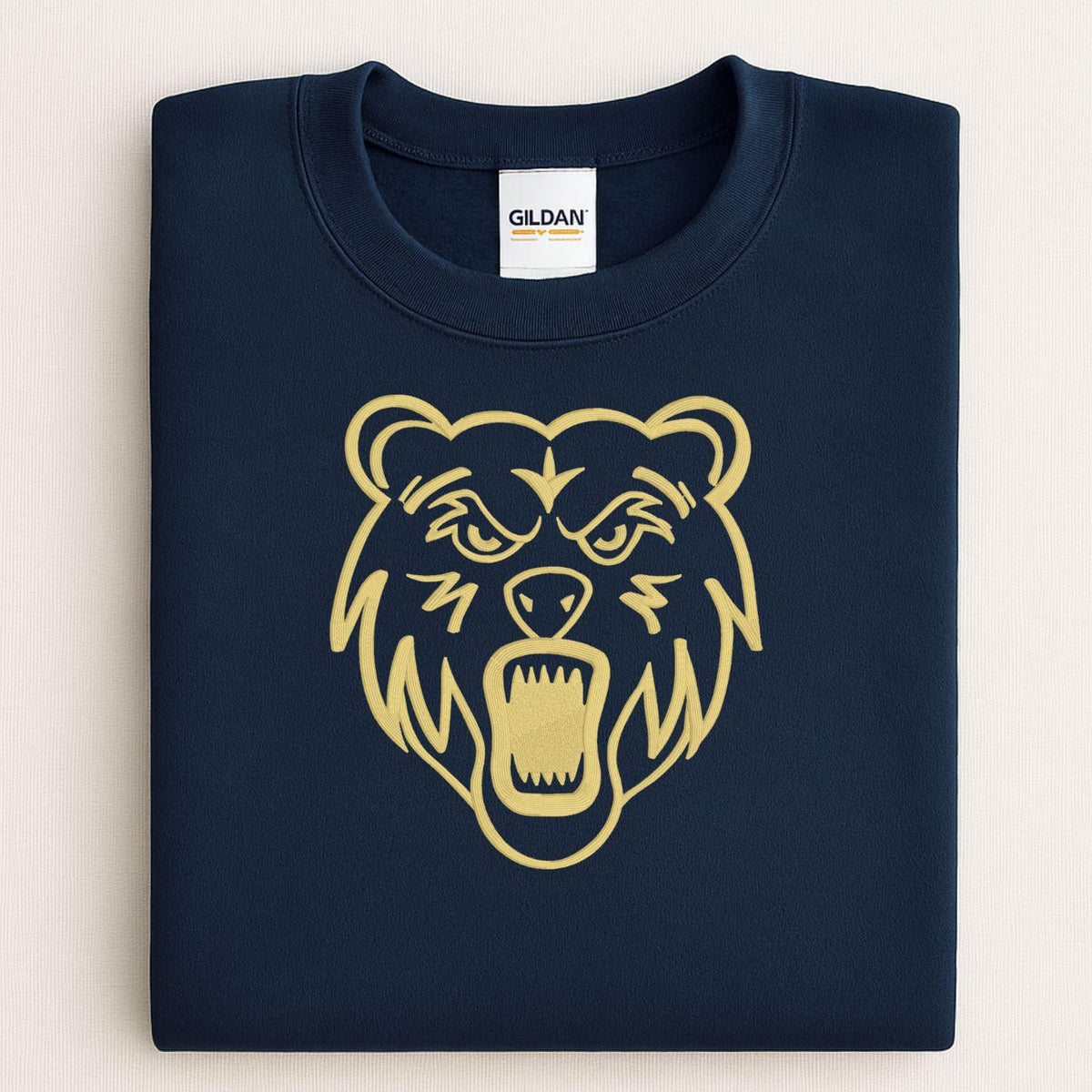 Navy sweatshirt with full-front gold bear mascot embroidery folded flat