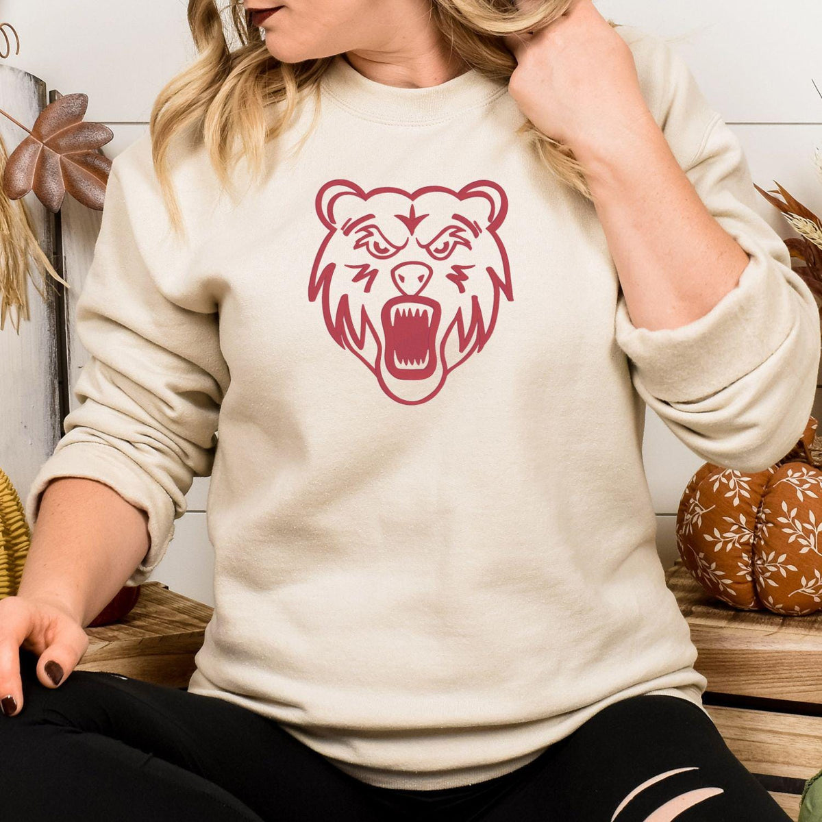 Sand sweatshirt with red full-front bear mascot embroidery modeled indoors