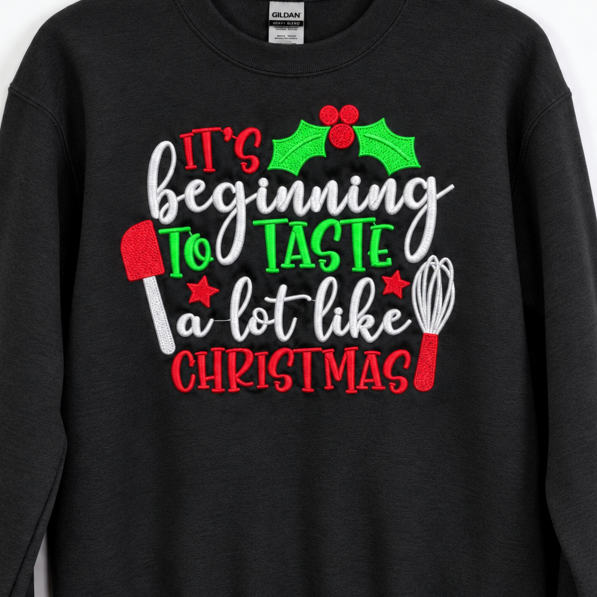 Close-up of red green and white Christmas baking embroidery on black sweatshirt