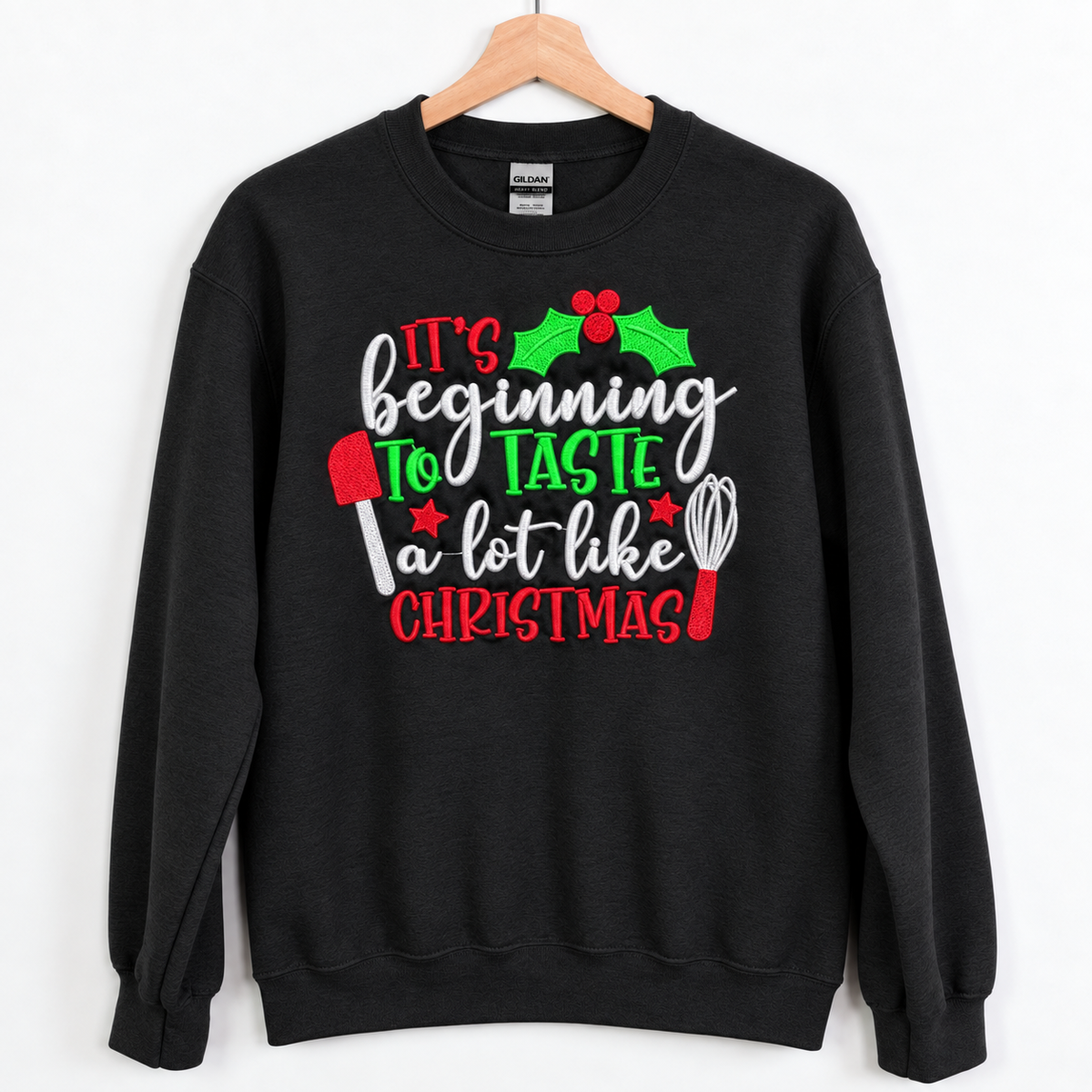 Black Christmas baking embroidered crewneck sweatshirt on a wooden hanger