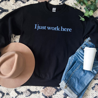 Black Gildan crewneck with blue embroidered I just work here text