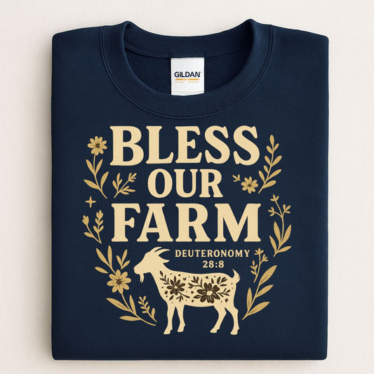 Folded navy Bless Our Farm Christian sweatshirt with gold goat and floral graphic