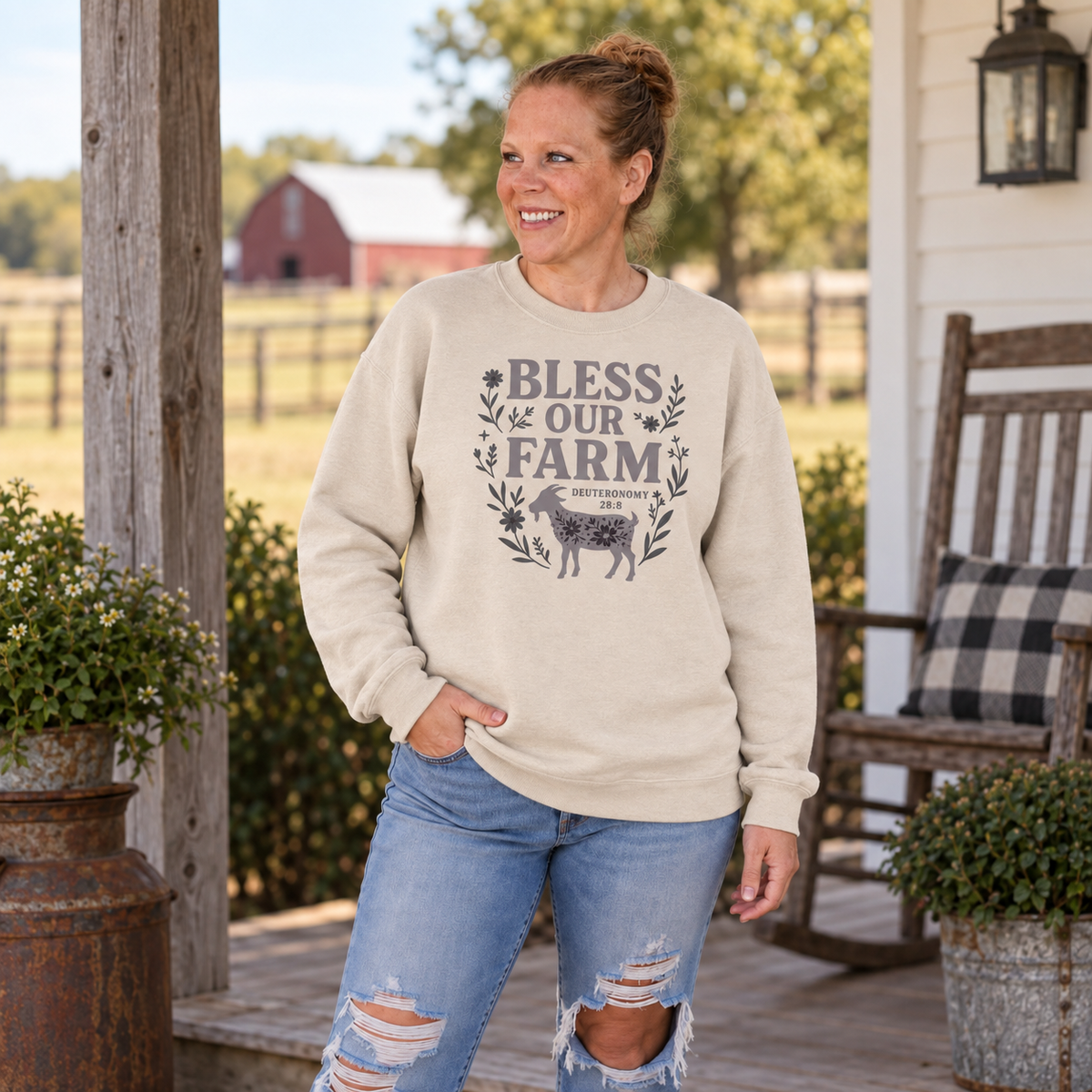Samantha wearing sand Bless Our Farm Christian sweatshirt on a farm porch