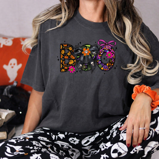 Colorful BOO Halloween graphic on a Pepper Comfort Colors 1717 tee in a spooky lifestyle scene.