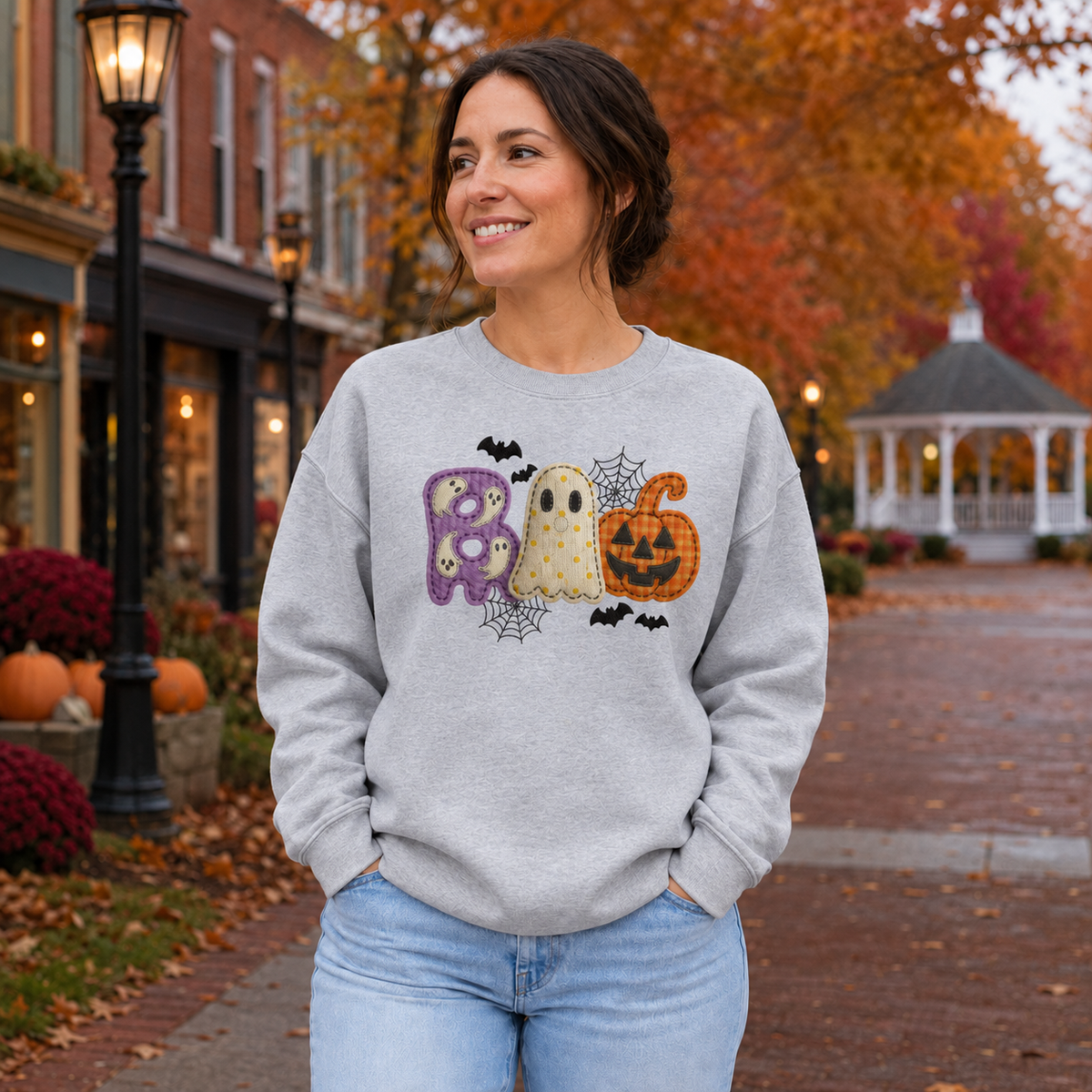 Adult wearing Sport Grey Gildan Softstyle BOO Halloween sweatshirt with ghost and pumpkin design