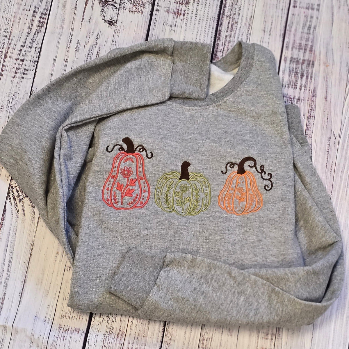 Sport Grey embroidered sweatshirt with three botanical pumpkins in coral, olive, orange and brown thread