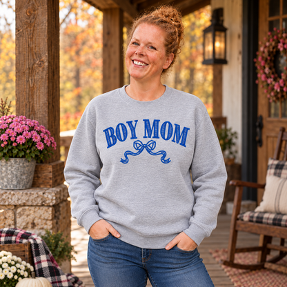 Samantha wearing an Ash Gildan Softstyle Boy Mom sweatshirt with royal blue bow embroidery