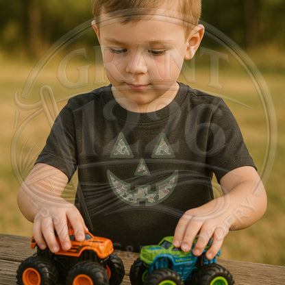 Toddler wearing Black camouflage pumpkin Halloween shirt while playing