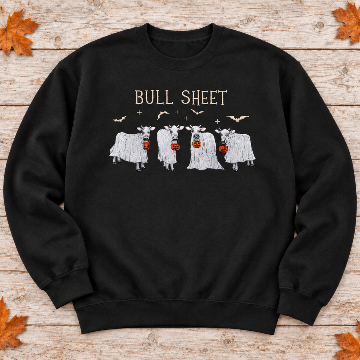 Black Bull Sheet cow ghost embroidered sweatshirt flat lay, with cream lettering and bats