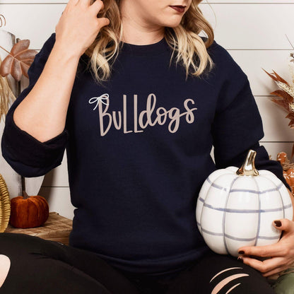 Navy Bulldogs embroidered sweatshirt modeled while holding a white pumpkin