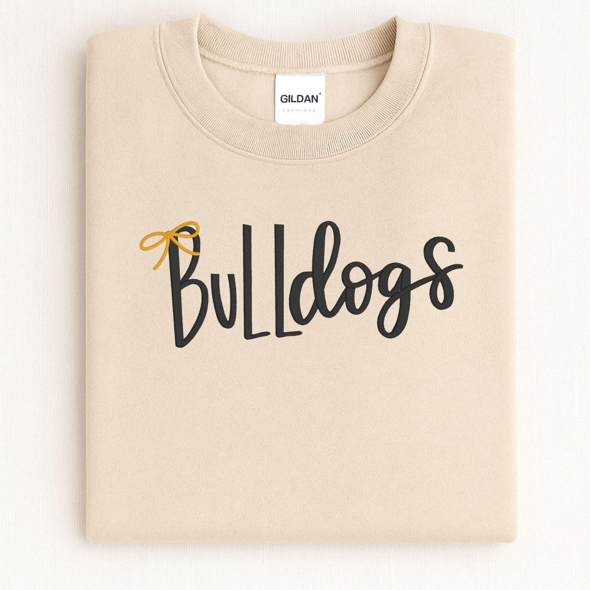 Sand Bulldogs embroidered crewneck folded on a light background