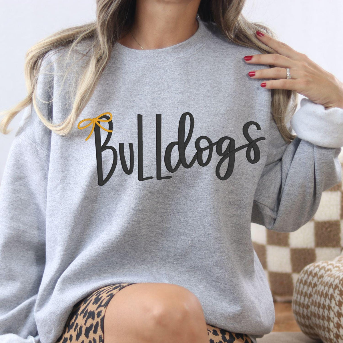 Sport gray Bulldogs bow embroidered sweatshirt modeled with leopard-print pants