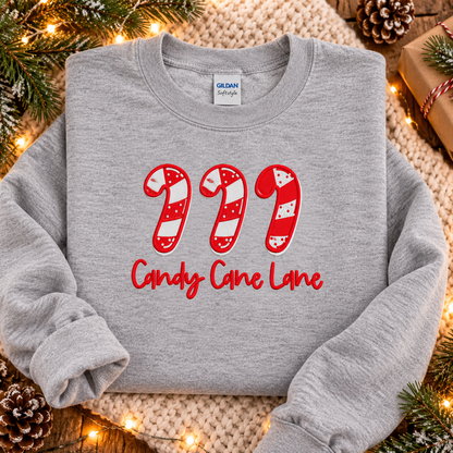 Sport Grey Candy Cane Lane embroidered sweatshirt folded with Christmas greenery