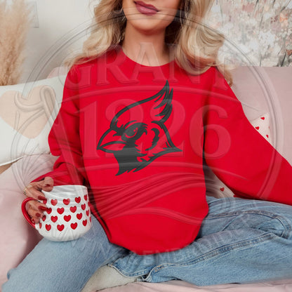 Woman wearing red Cardinal spirit sweatshirt with black embroidered mascot