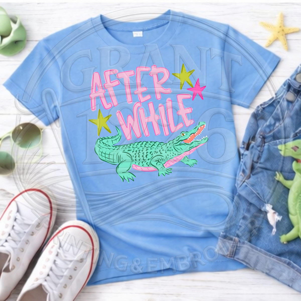 Carolina blue family matching alligator shirt set in a flat lay