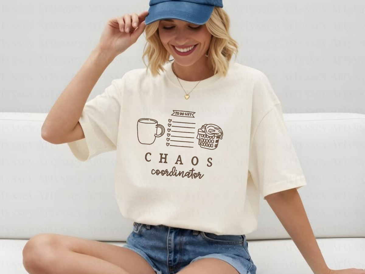 Ivory short-sleeve Chaos Coordinator embroidered adult shirt on seated model