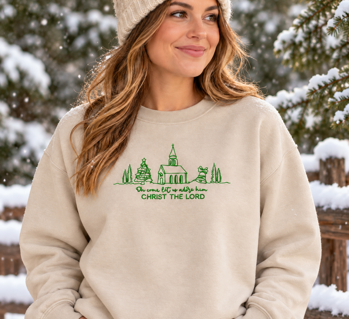 Sand Christ the Lord embroidered sweatshirt flat lay with evergreen accents