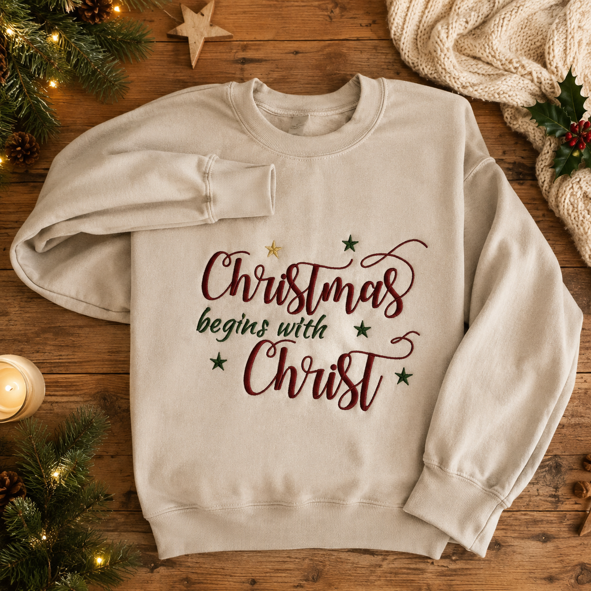 Christmas Begins With Christ embroidered sweatshirt in Sand with seasonal maroon green and gold thread