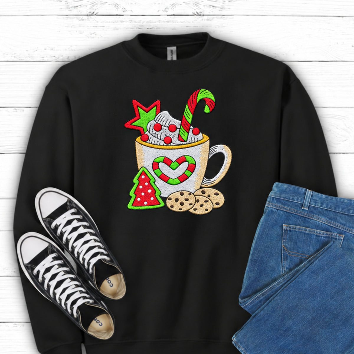 Close-up of cocoa mug candy cane and cookies embroidery on Black sweatshirt