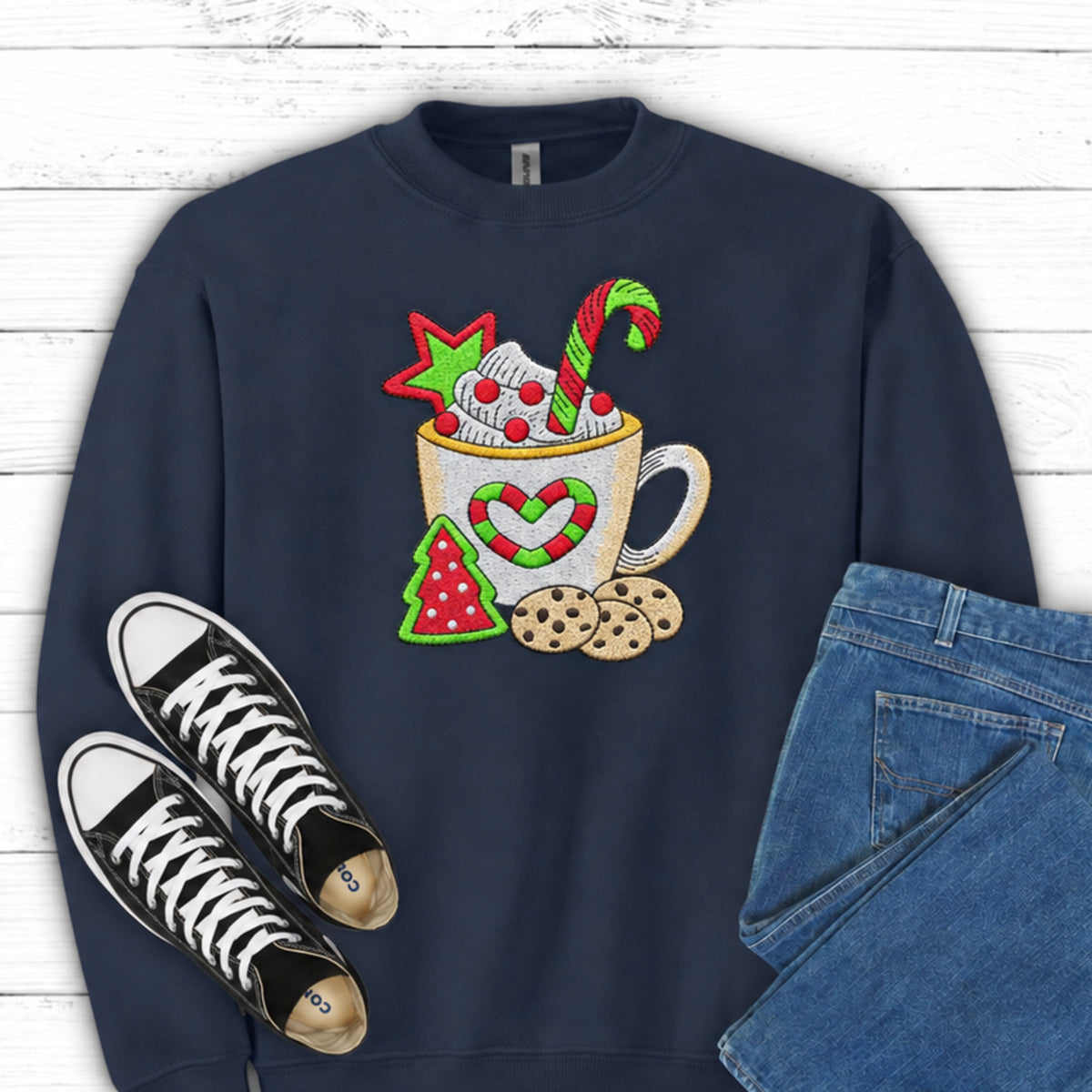Close-up of cocoa mug candy cane and cookies embroidery on Navy sweatshirt