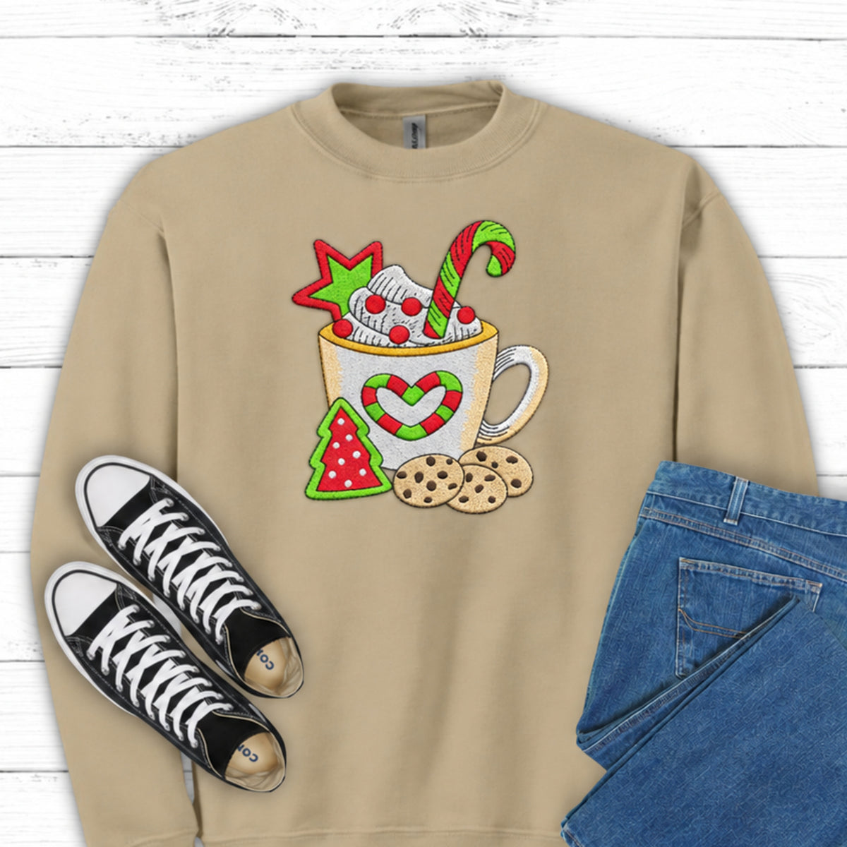Close-up of cocoa mug candy cane and cookies embroidery on Sand sweatshirt