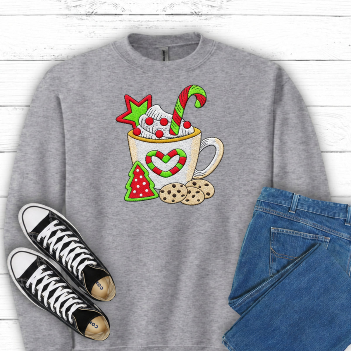 Close-up of cocoa mug candy cane and cookies embroidery on Sport Grey sweatshirt