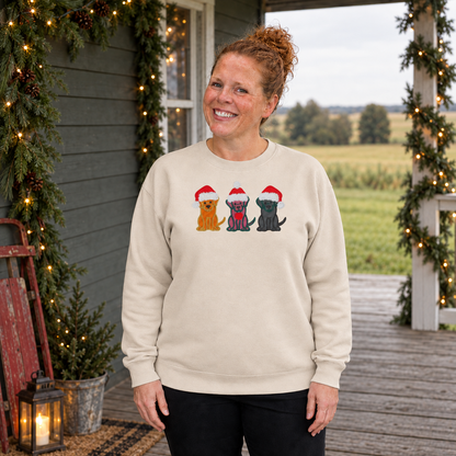Samantha wearing a Sand Gildan sweatshirt embroidered with three Christmas dogs in Santa hats