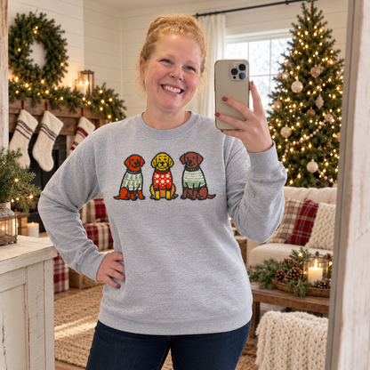 Samantha wearing a heather grey embroidered Christmas dog sweatshirt in a farmhouse holiday room