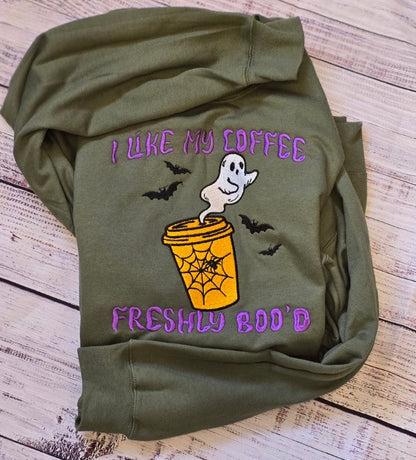 Real stitch-out of I Like My Coffee Freshly Boo'd embroidery in purple, orange, white and black