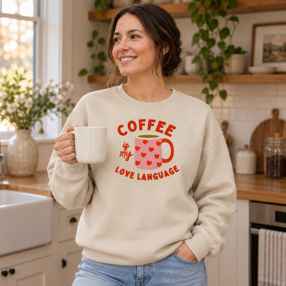 Woman wearing Sand Gildan Softstyle sweatshirt with coffee love language embroidery