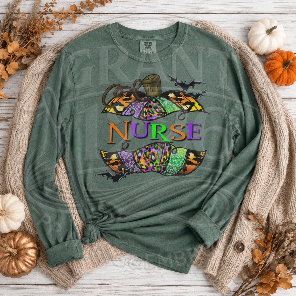 Comfort Colors Blue Spruce long sleeve Halloween nurse shirt flat lay with patterned pumpkin and bats
