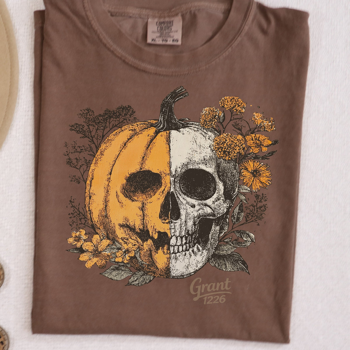 Comfort Colors Espresso shirt flat lay with floral pumpkin skull design
