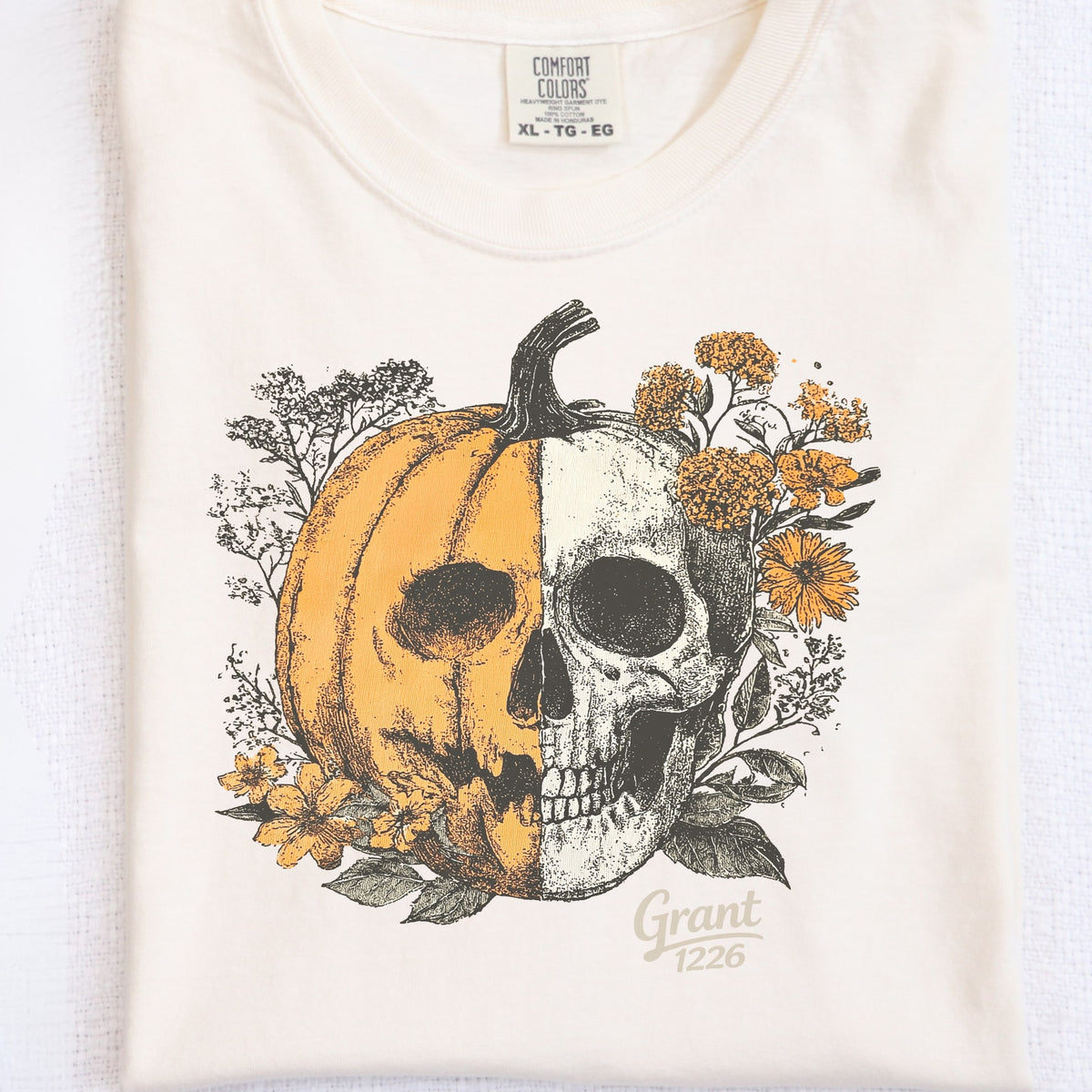 Detail view of Comfort Colors Ivory pumpkin skull Halloween shirt