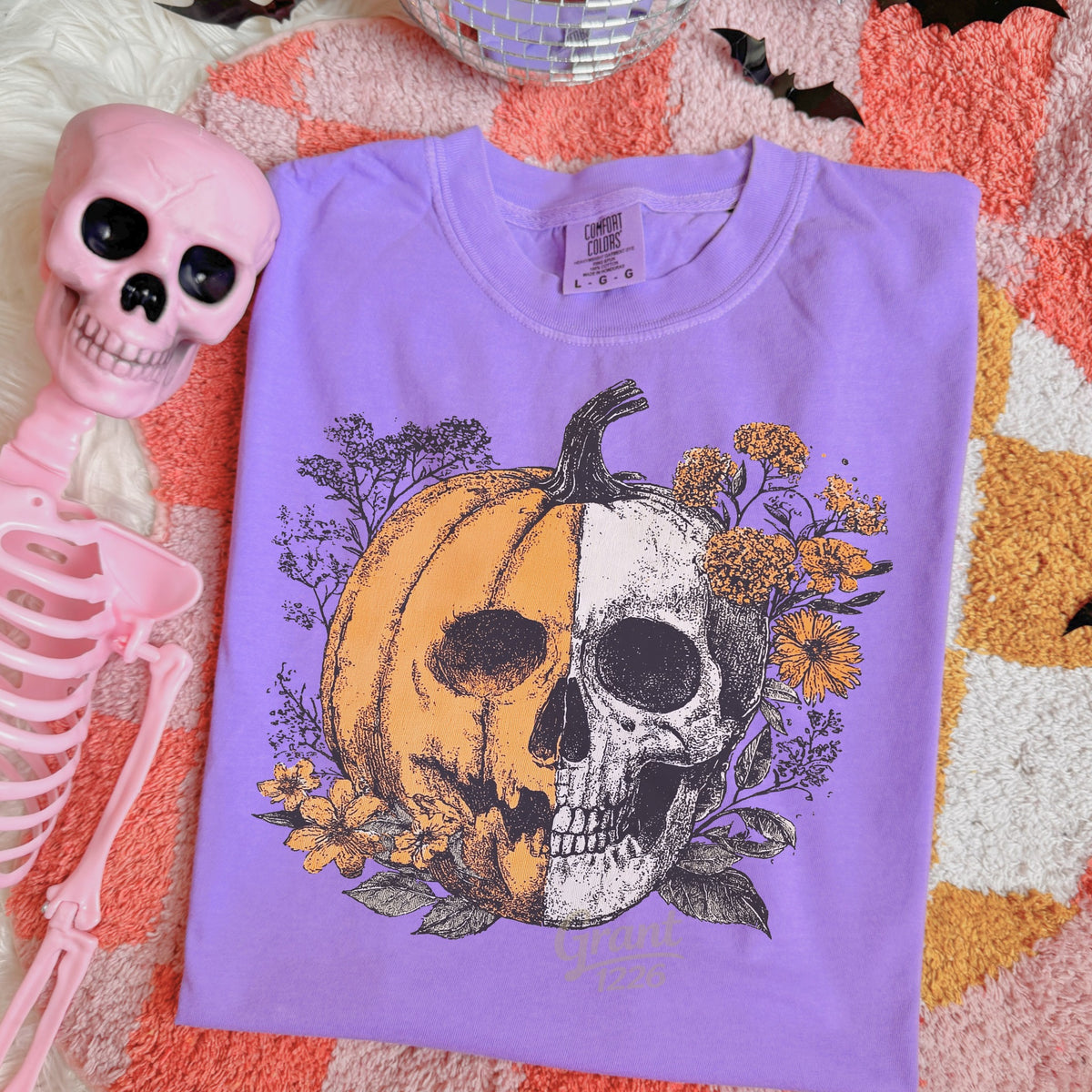 Comfort Colors Violet shirt flat lay with floral pumpkin skull Halloween design