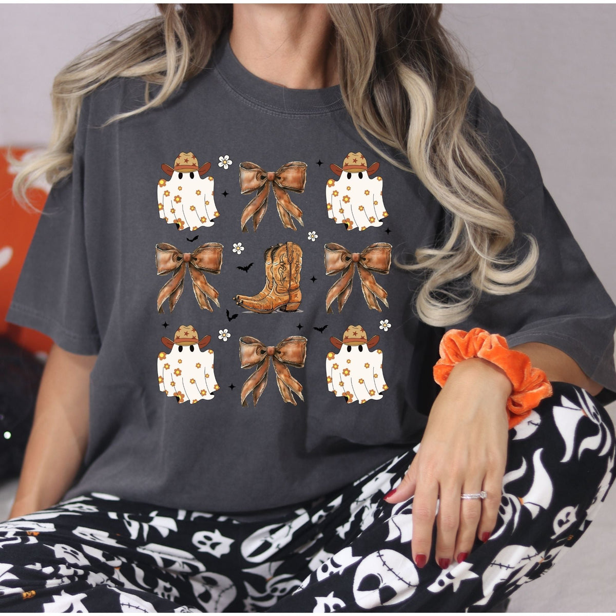 Front view of the Pepper Comfort Colors cowgirl ghost shirt with rustic bows and western boot artwork.