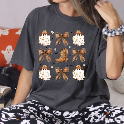 Close view of the Pepper Comfort Colors cowgirl ghost Halloween shirt with bows and a western boot.