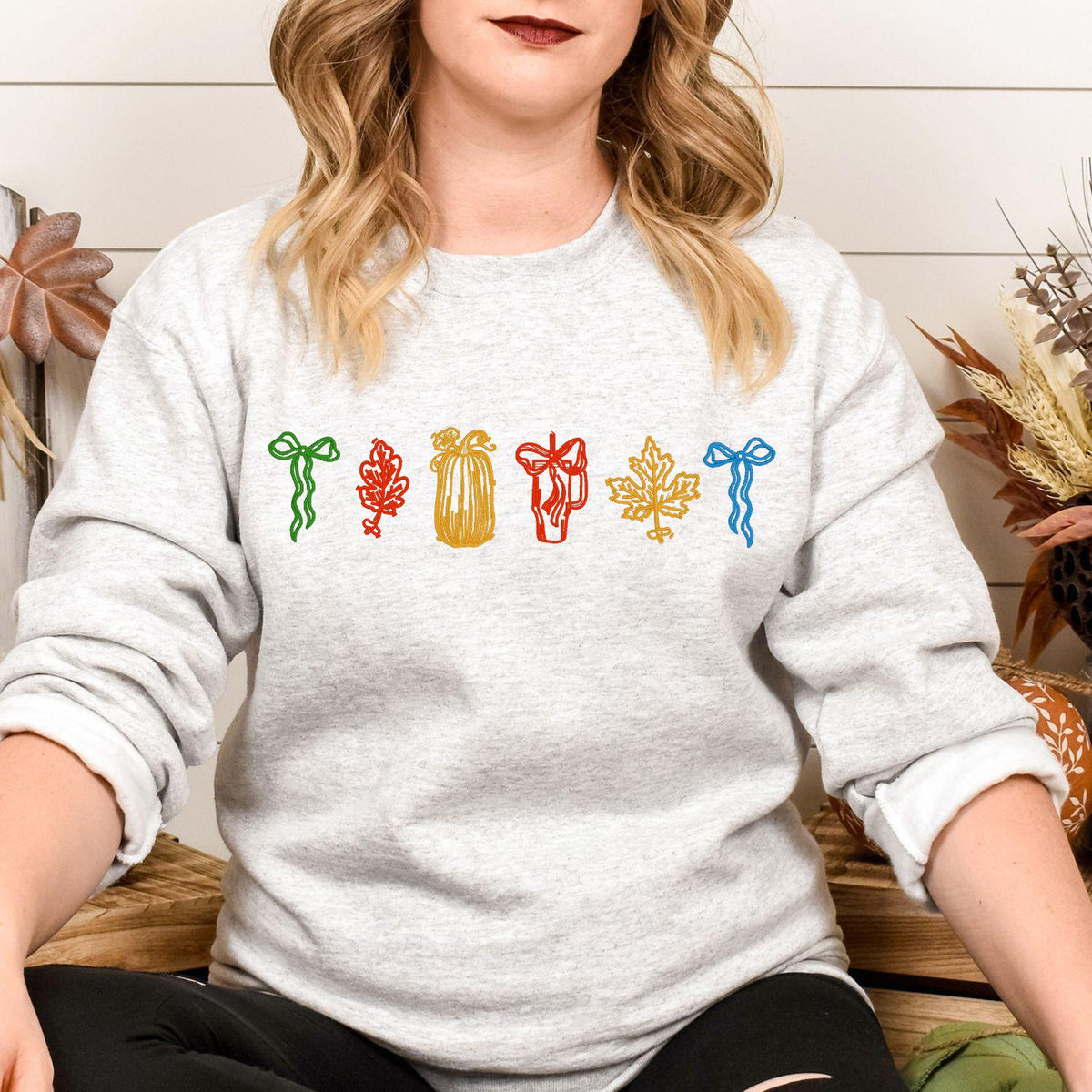 Sport gray colorful fall embroidery sweatshirt modeled while seated
