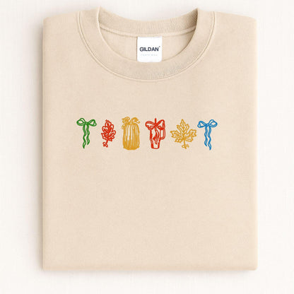 Sand cozy fall embroidered crewneck folded on a light background